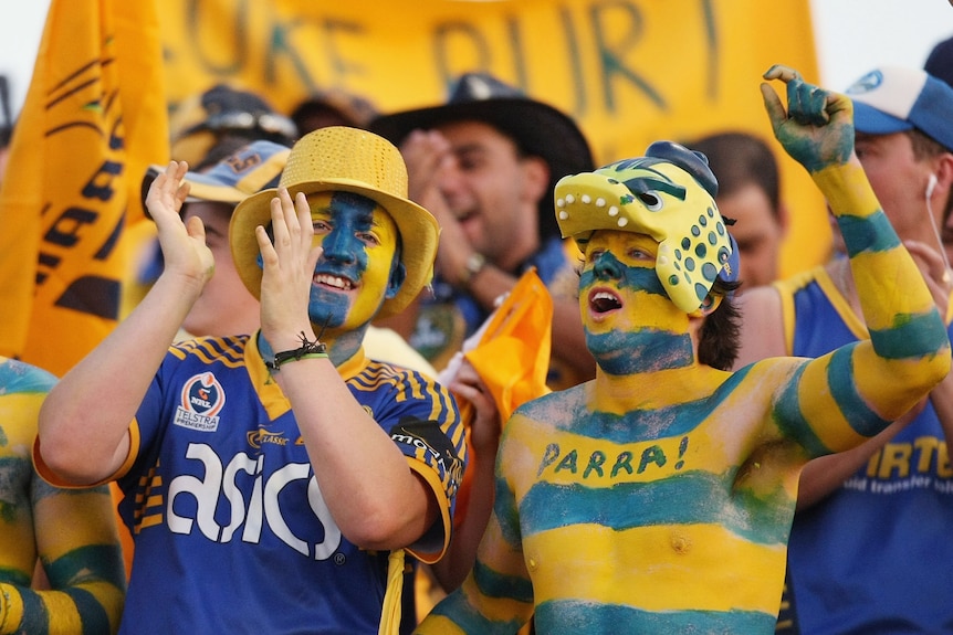 A group of Parramatta fans celebrate a try