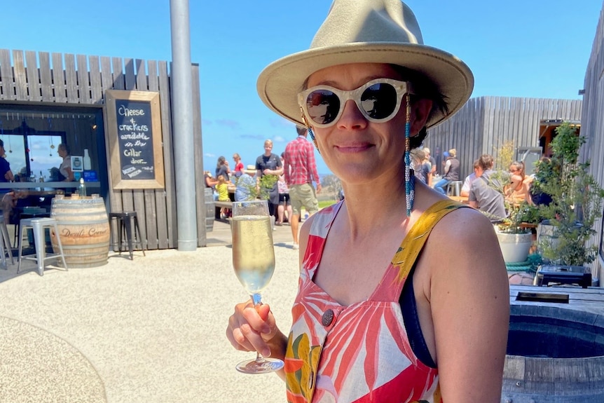 A woman holding a glass of champagne.