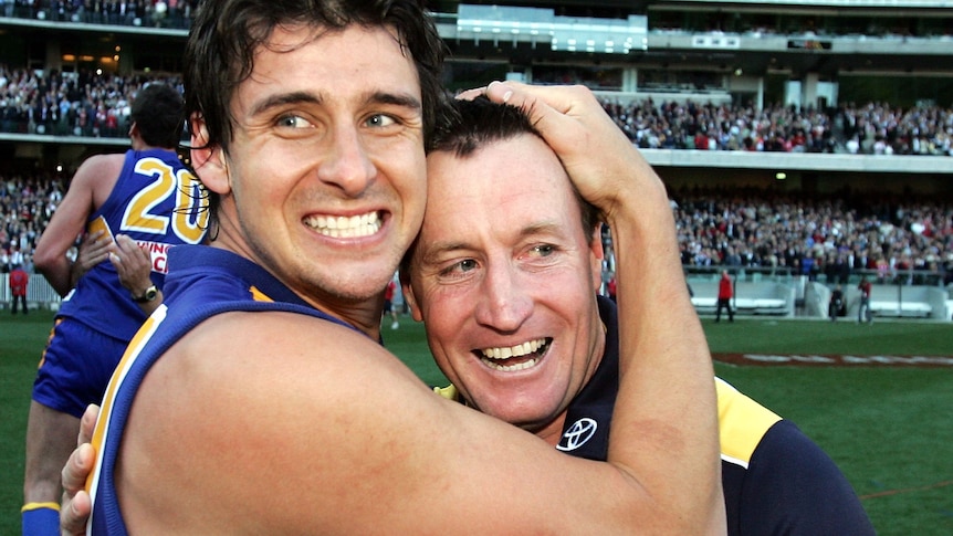 Andrew Embley smiles as he holds John Worsfold's head