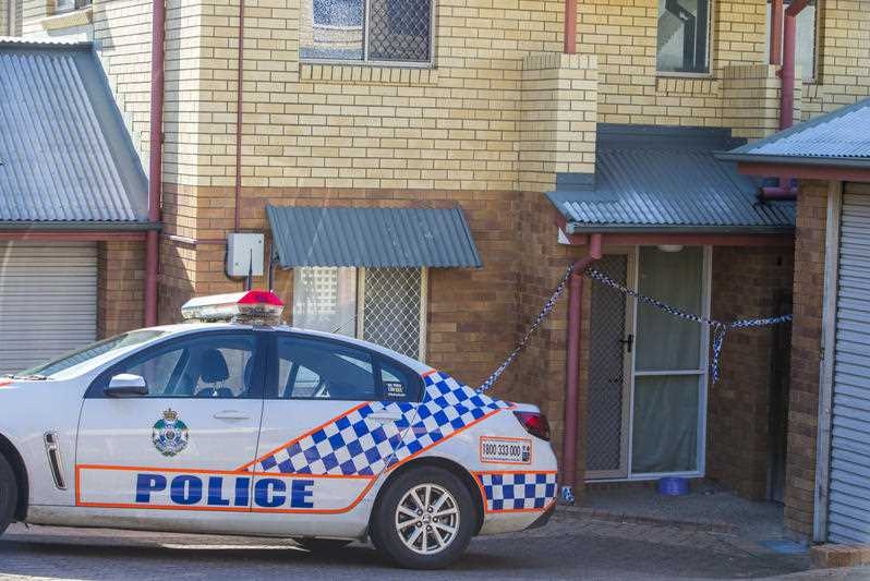 A police car and police tape outside a Northgate brick townhouse where a toddler was injured and later died in hospital.