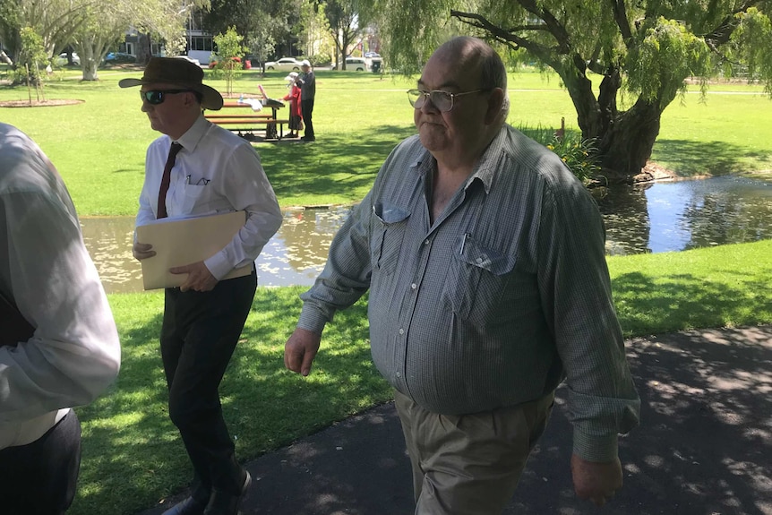 Peter Dansie and one of his lawyers walking through a park in Adelaide.