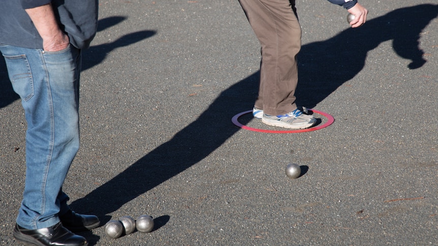 Players must stand in a circle before they throw the boule and cochonnet at least six metres.