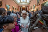 Queen Camilla surrounded by a crowd of women 