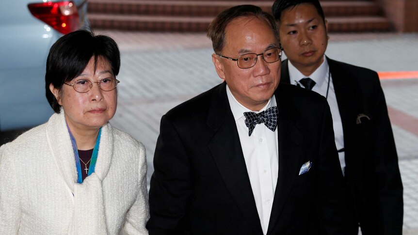 Donald Tsang arrives at court with his wife.
