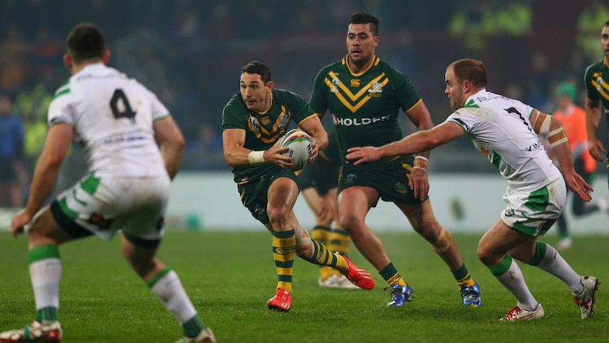 Australia's Billy Slater (C) makes a break against Ireland at the Rugby League World Cup.