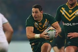 Australia's Billy Slater (C) makes a break against Ireland at the Rugby League World Cup.