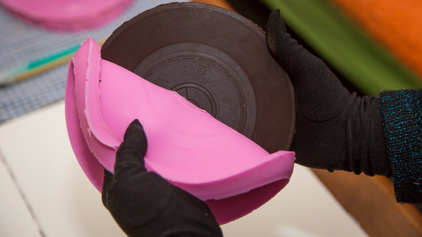 Julia Drouhin peels back the silicone mould from the chocolate carefully to ensure the record sounds good.