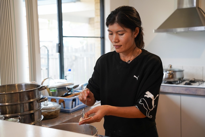 Sonam Lhamo making dumplings in her kitchen