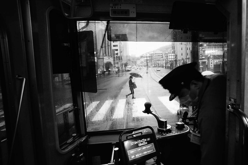 A black and white photo of a busy street.