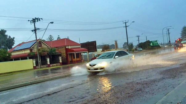 Car drives through big puddle