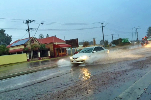 Car drives through big puddle