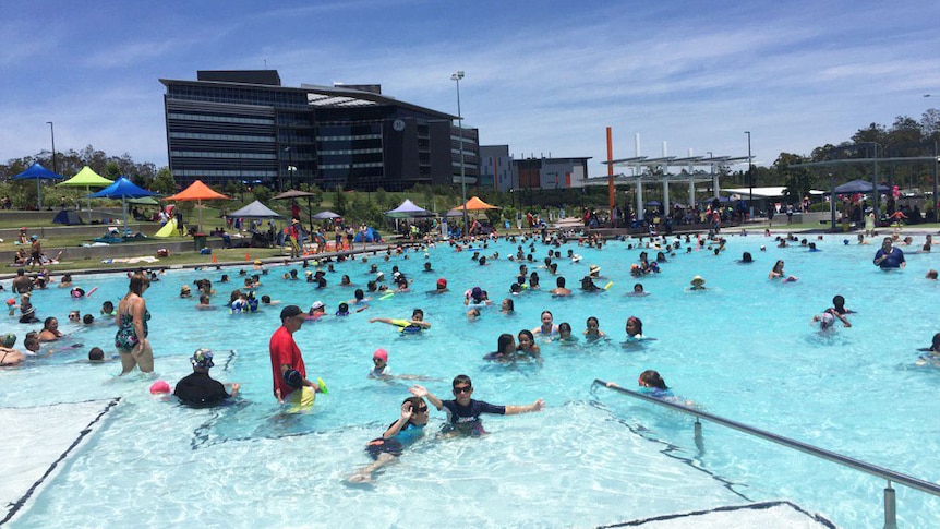 People cooling off from the heat at Springfield, west of Brisbane