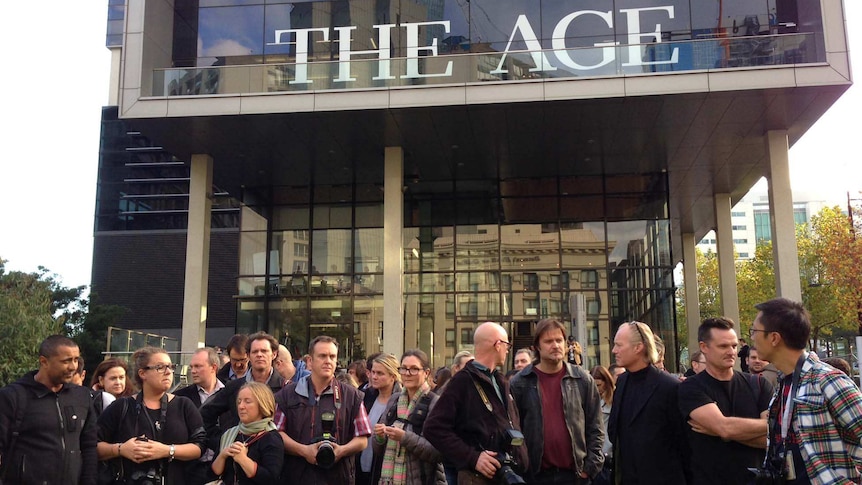 Fairfax staff members gather outside the company's Melbourne headquarters.