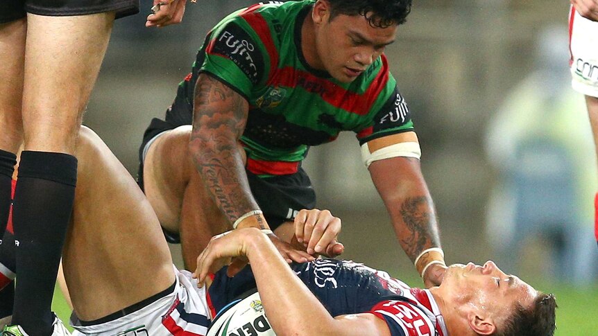 South Sydney's Isaac Luke checks on the Roosters' Sonny Bill Williams