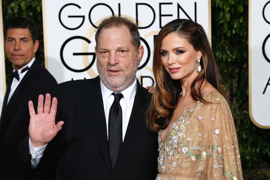 Harvey Weinstein waves on the red carpet with his wife Georgina Chapman