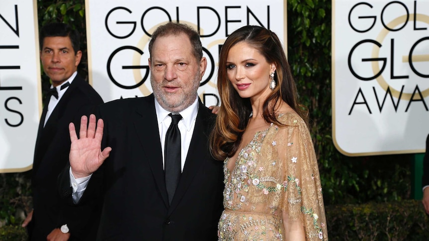 Harvey Weinstein waves on the red carpet with his wife Georgina Chapman