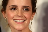 Actor Emma Watson smiles at the camera.