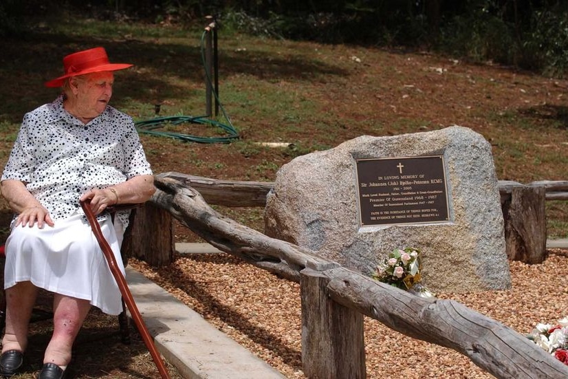 Lady Flo Bjelke-Petersen sitting next to the grave of her husband Sir Joh Bjelke-Petersen