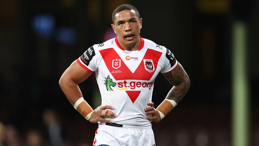 A St George Illawarra NRL player stands with his hands on his hips during a match.