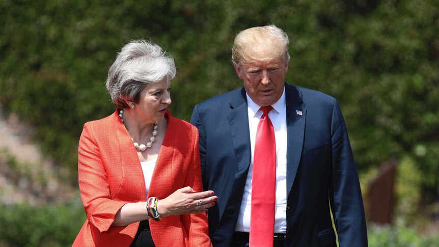 British Prime Minister Theresa May walks with U.S President Donald Trump prior to a joint press conference at Chequers, in Buckinghamshire, England.