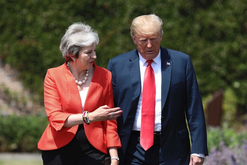 British Prime Minister Theresa May walks with U President Donald Trump prior to a joint press conference at Chequers, in Buckinghamshire, England.