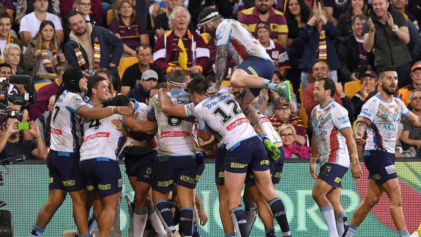 Gold Coast Titans celebrate their momentous win over Melbourne