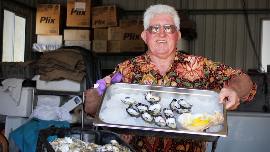 Jim Wild holds a tray of oysters with ice and lemon.