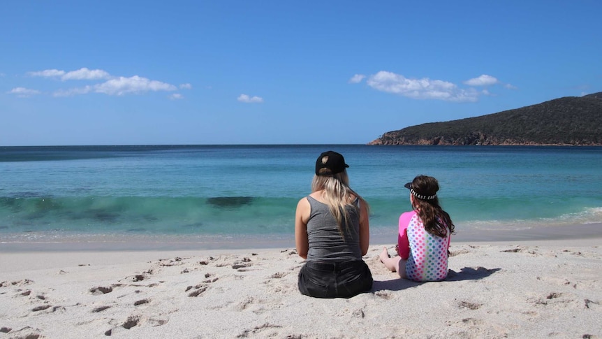 Mother and daughter looking out to the water at Coles Bay, Tasmania.