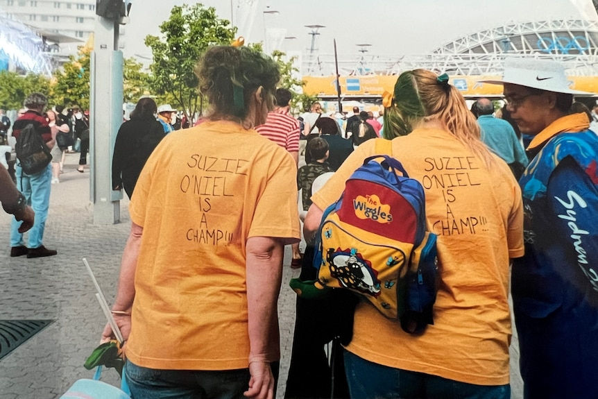 The back of two fans wearing t-shirts in support of Susie O'Neill.