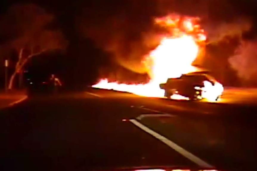 A ute engulfed in flames rolling down a street in Canberra.