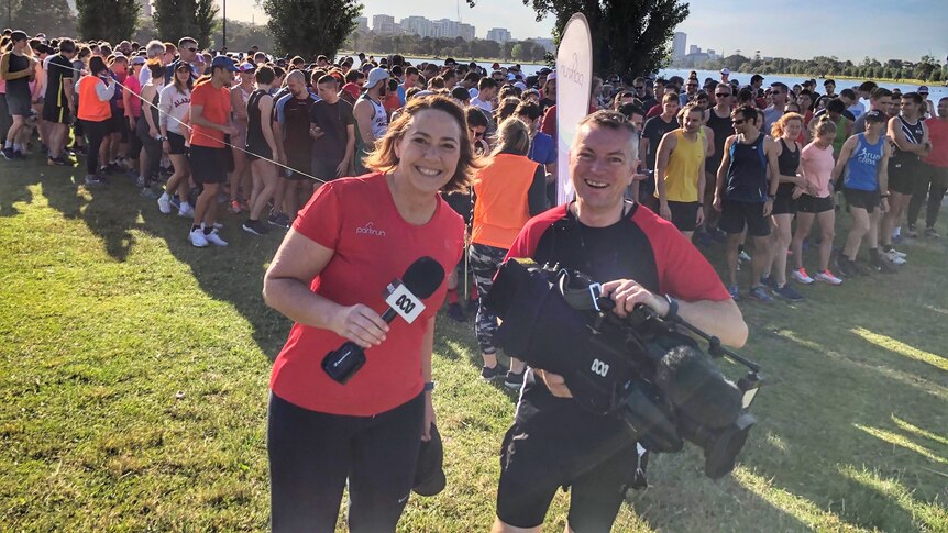 Lisa Millar and her cameraman pose for a photo at Parkrun in Melbourne.