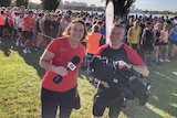 Lisa Millar and her cameraman pose for a photo at Parkrun in Melbourne.