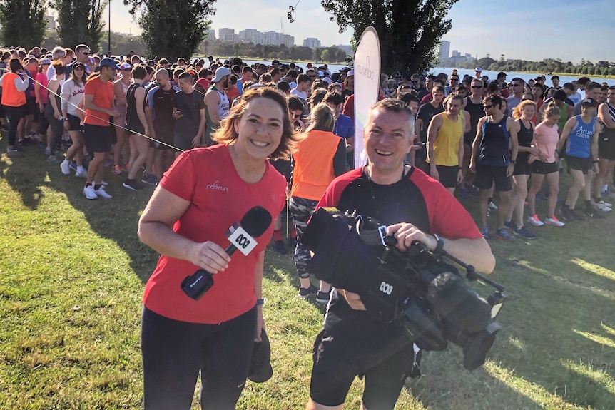 Lisa Millar and her cameraman pose for a photo at Parkrun in Melbourne.