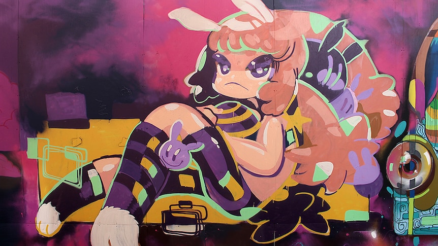 A street art mural of a girl with bunny ears.