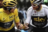 Britain's Geraint Thomas, left, wearing the overall leader's yellow jersey and Britain's Christopher Froome toast with Champagne