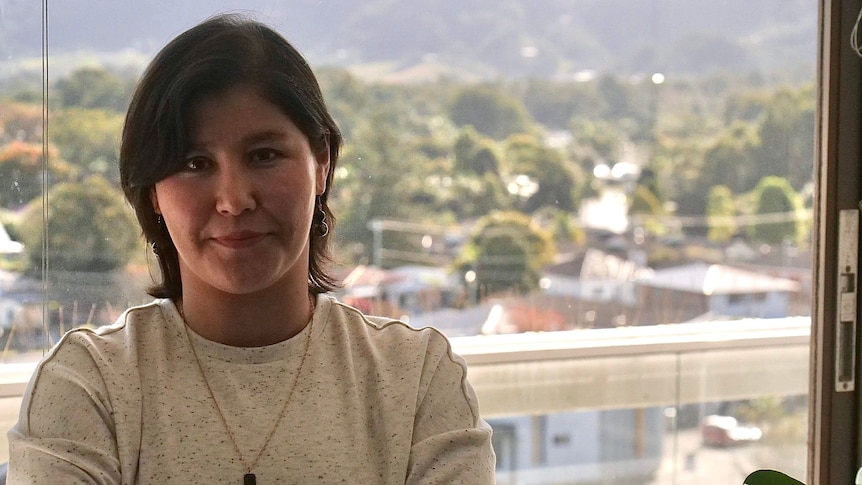 Mitra Hussaini, a young Afghan woman, posing for a photo on her office balcony in Coffs Harbour.  