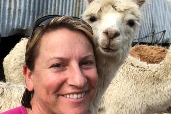 Lady smiling with Alpaca