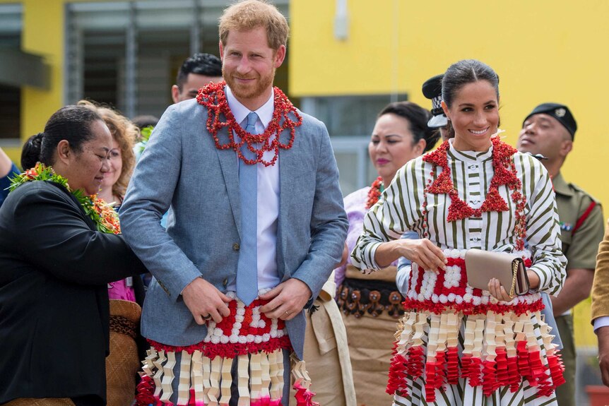 Harry and Meghan wear a ta'ovala, a traditional Tongan dress wrapped around the waist.