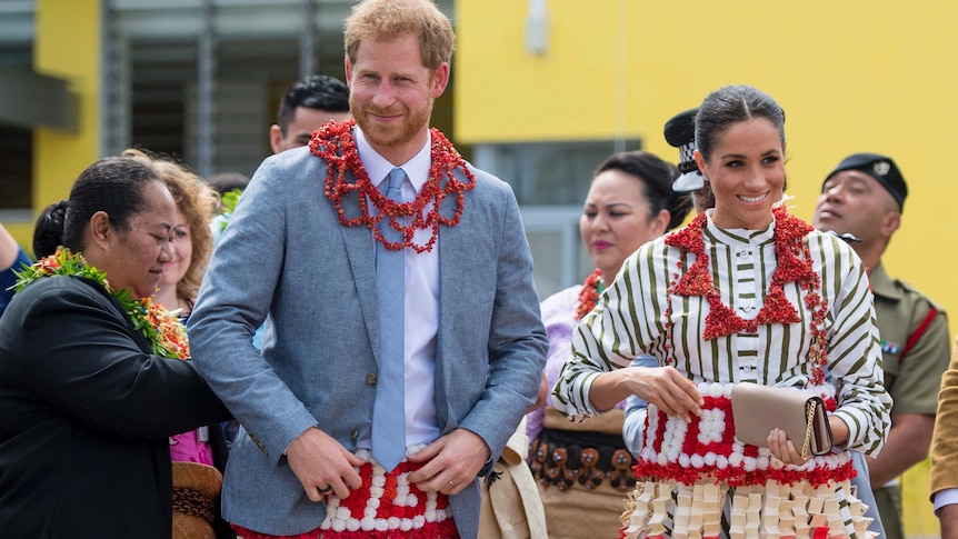 Harry and Meghan wear a ta'ovala, a traditional Tongan dress wrapped around the waist.