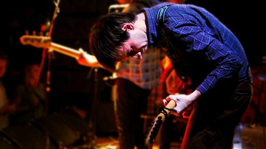 Dick Diver performs on electric guitar on a live stage at the Tote Hotel in Melbourne