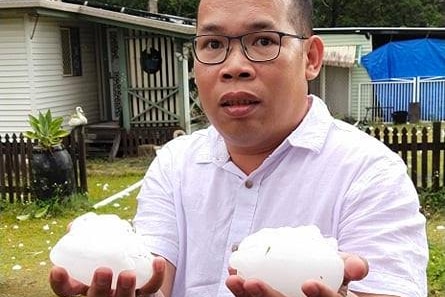 Jimmy Balista holding two pieces of hail. 