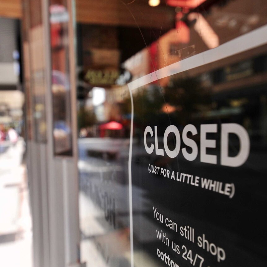 A sign on a Rundle Mall shop with a black background reads 'CLOSED (just for a little while)' in white text.'