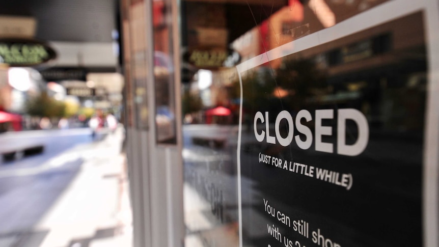 A sign on a Rundle Mall shop with a black background reads 'CLOSED (just for a little while)' in white text.'