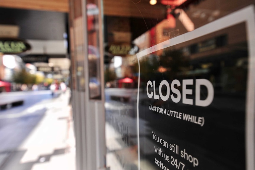 A sign on a Rundle Mall shop with a black background reads 'CLOSED (just for a little while)' in white text.'