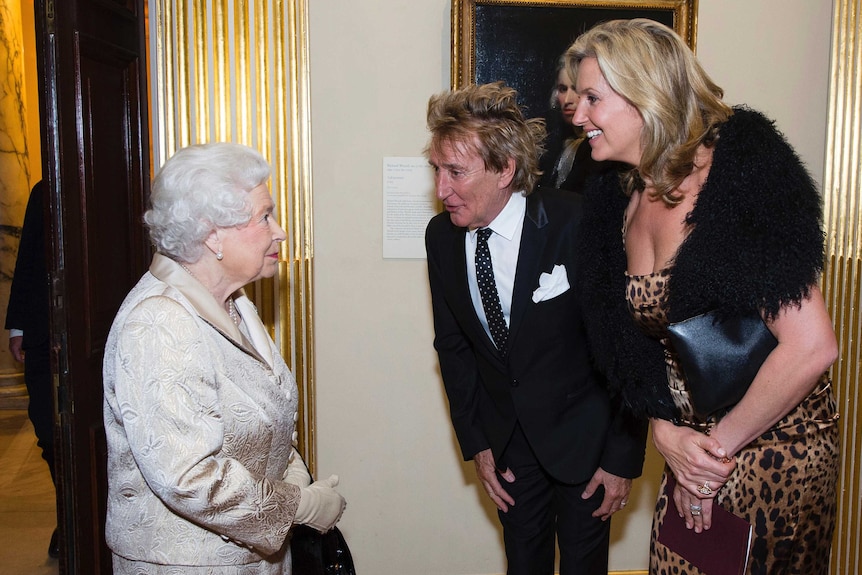 Britain's Queen Elizabeth, left, greets Sir Rod Stewart