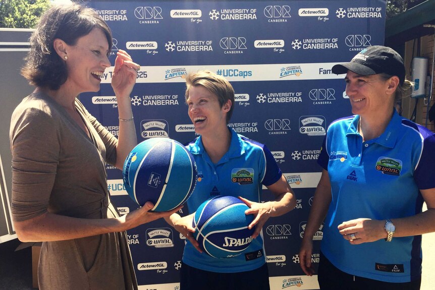 Former Canberra Capitals champion Lucille Bailey with Jessica Bibby and coach Carrie Graf.