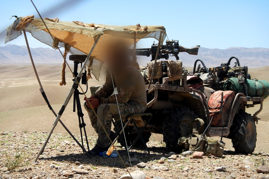 SAS soldier looking out under sun shade in Afghanistan in 2012.