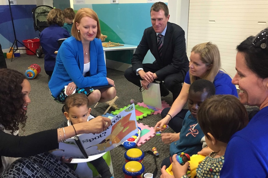 Federal Minister for Social Services Christian Porter with WA Disability Services Minister Dona Faragher crouch with children.