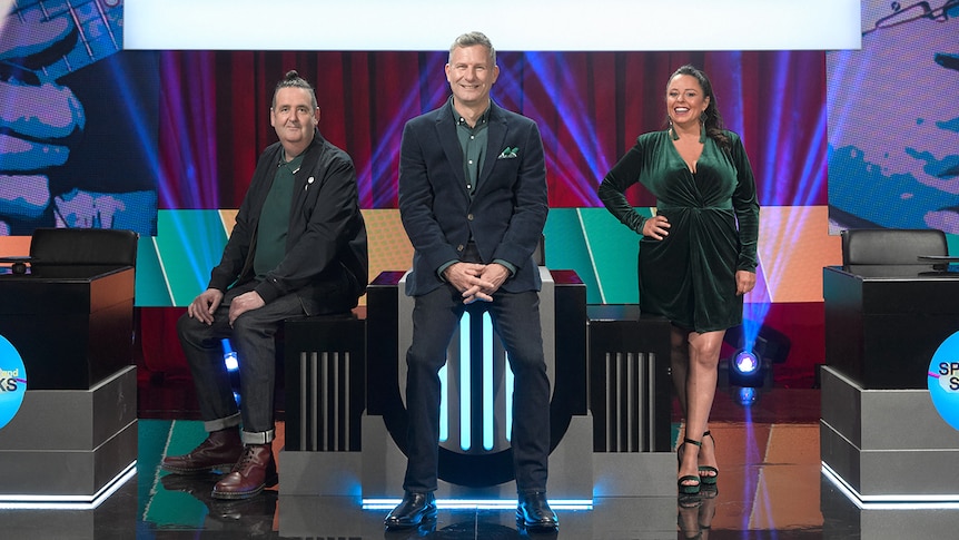 Alan Brough, Adam Hills and Myf Warhurst wear formal clothing on the set of Spicks and Specks