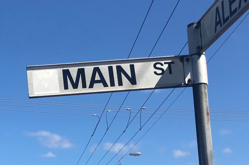 A street sign against a blue sky.